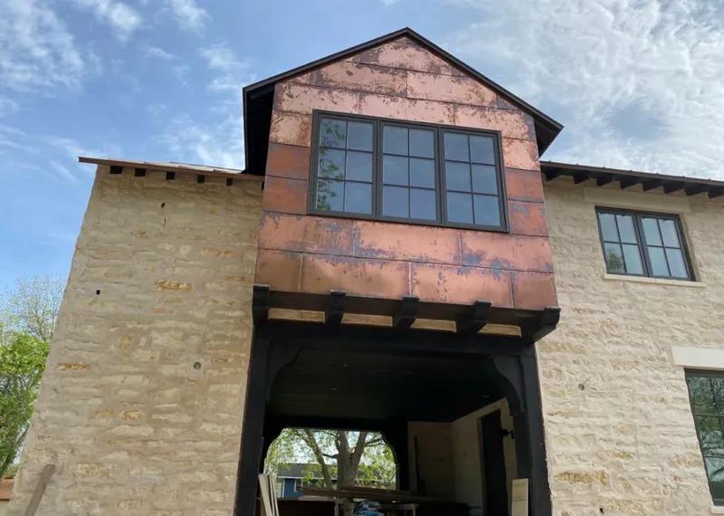 Copper metal panel facade on a stone building for Skylight Installation in Loganville