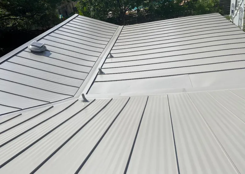 Solar attic fan installed on a metal roof for Roof Ventilation in Loganville